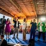 From left, Michigan Lt. Gov. Garlin Gilchrist, Michigan Gov. Gretchen Whitmer, Minnesota Gov. Tim Walz, Vice President Kamala Harris, Sen. Debbie Stabenow, and Rep. Elissa Slotkin greet the crowd during a campaign event.