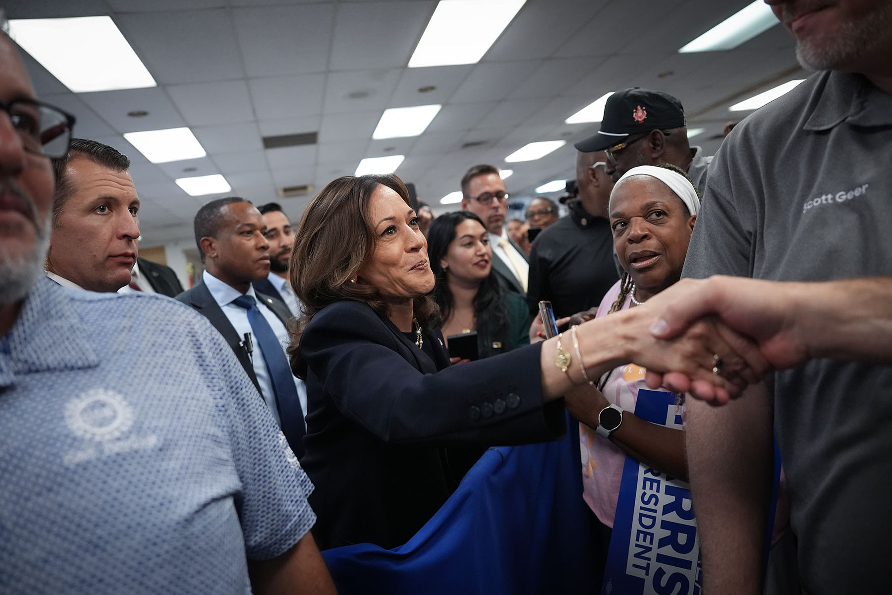 Vice President Harris greets audience members at a campaign rally at United Auto Workers Local 900.