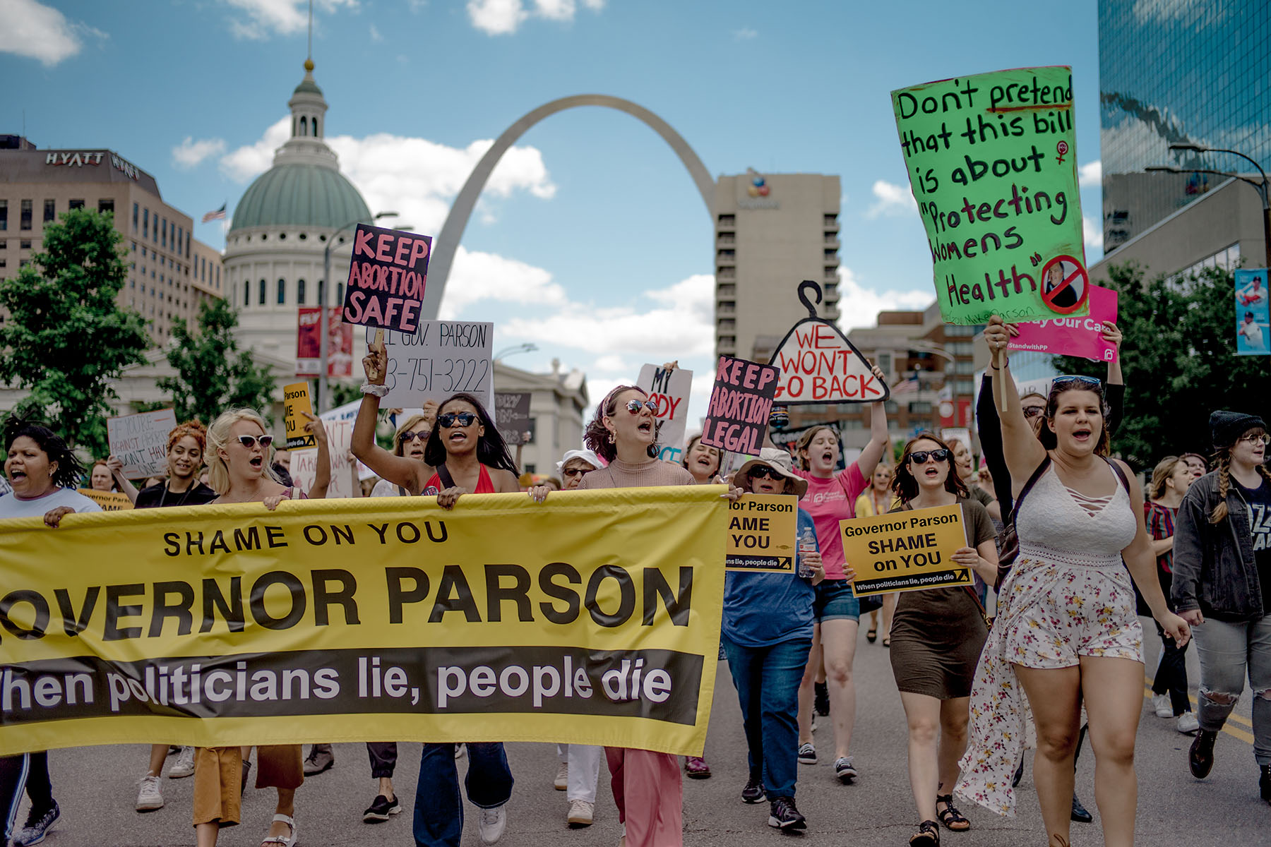 A group of protesters march in downtown St. Louis holding signs that say "Keep Abortion Safe" and "Shame on You Governor Parson," demonstrating against the closure of the last abortion clinic in Missouri.