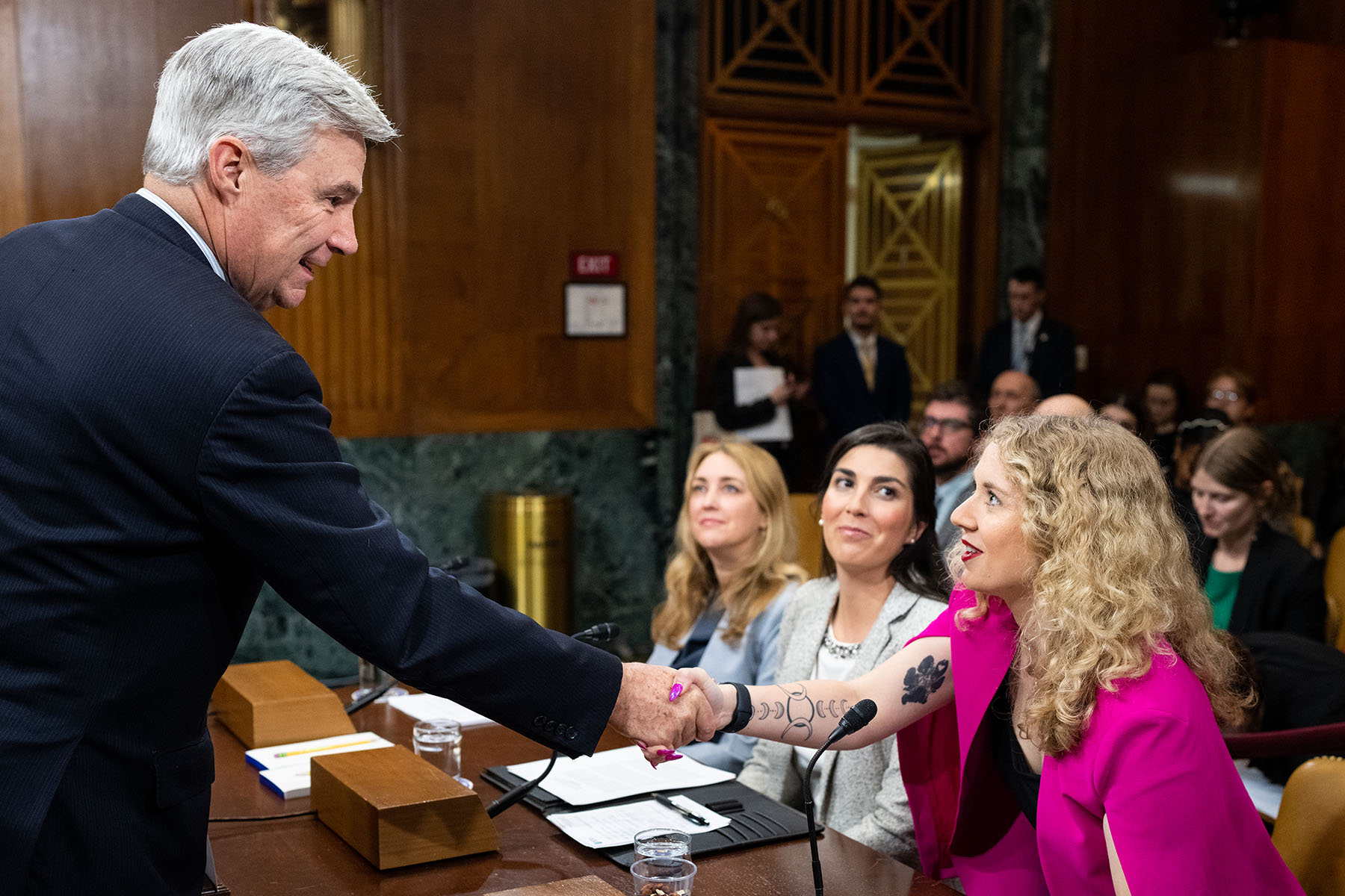 Allie Phillips shakes hands with Chairman Sheldon Whitehouse before the start of a Senate hearing on reproductive freedom.