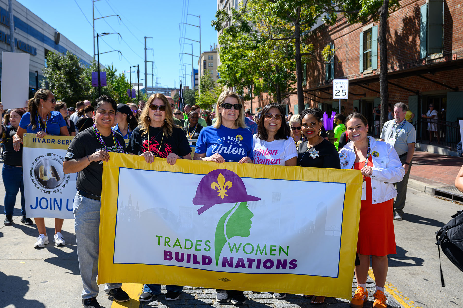 Liz Shuler (center) the first woman president of AFL-CIO marches with tradeswomen at their annual parade in New Orleans, Louisiana.