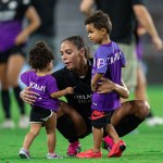 Sydney Leroux greets her two children on the field after a game in Orlando, Florida.
