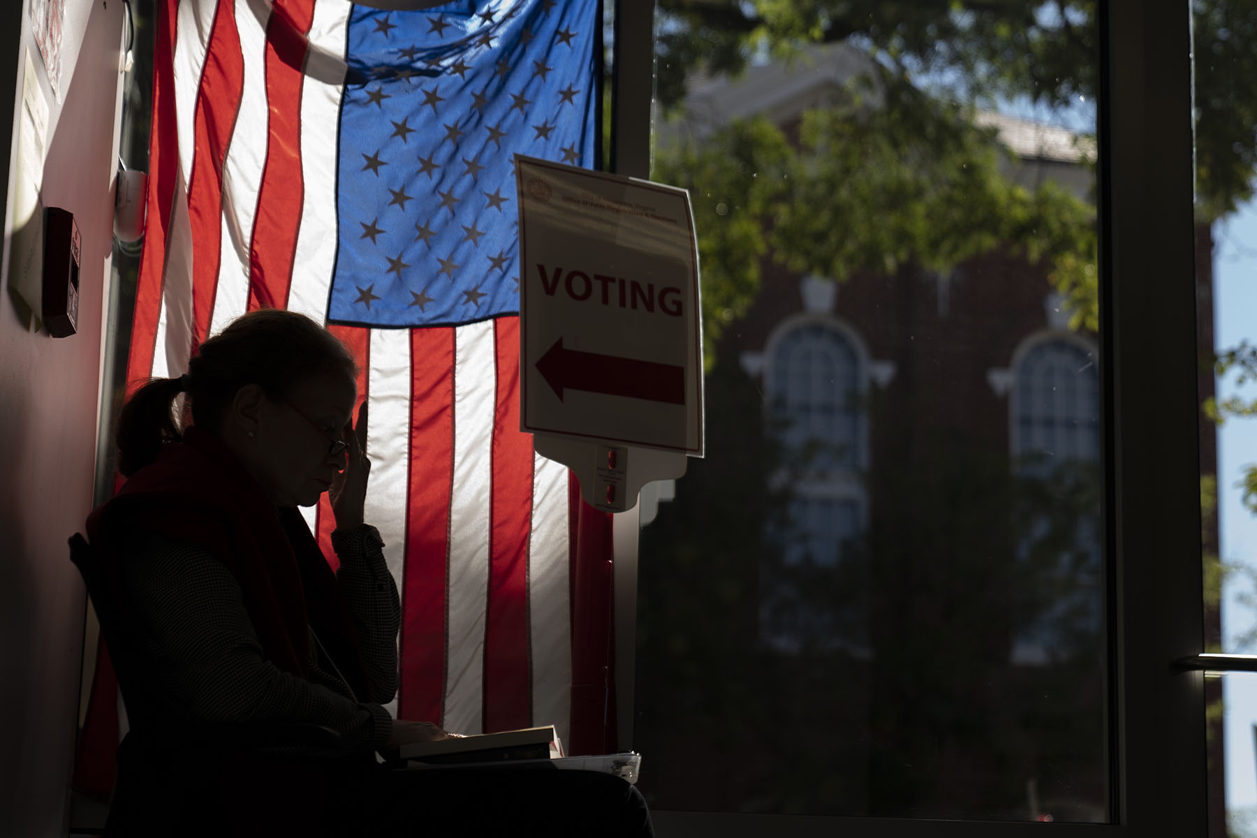 A poll worker waits to greet early voters in Alexandria, Virginia.