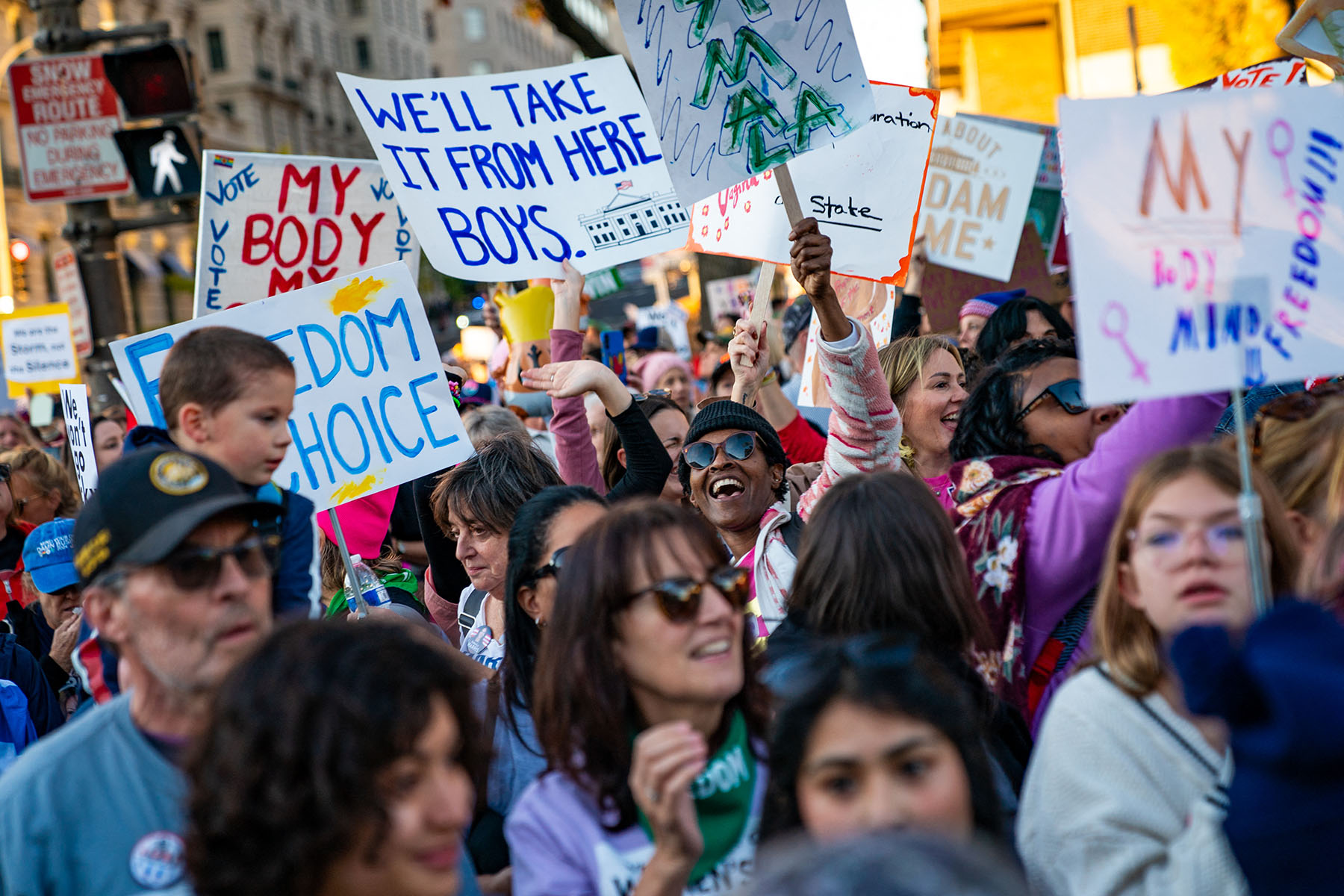 People participate in the National Women's March in Washington, D.C. A sign reads "We'll take it from here boys" with a drawn picture of the White House.