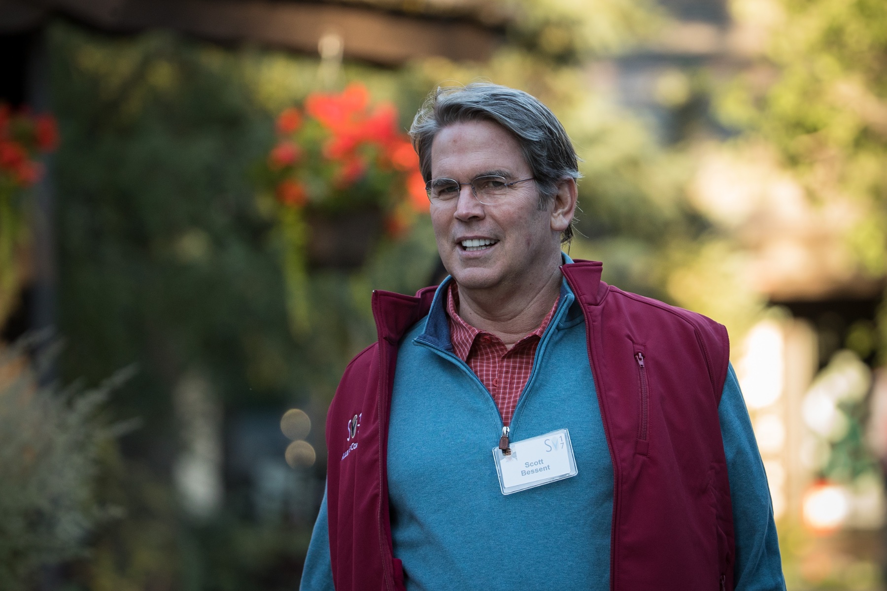 Image of Scott Bessent walking with a name tag on.