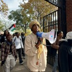 Students at Howard University protest Israeli attacks on Gaza as they hold banners and Palestinian flags.