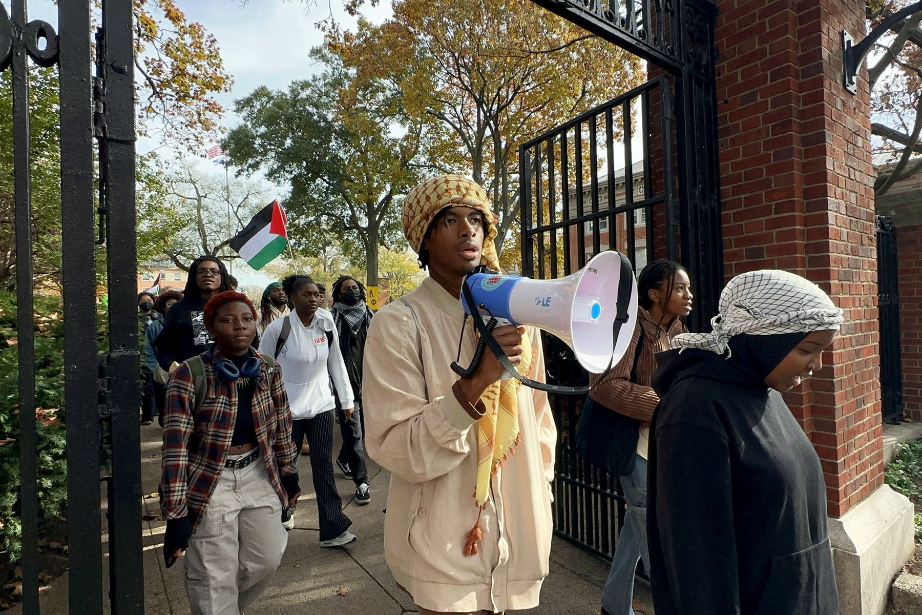 Students at Howard University protest Israeli attacks on Gaza as they hold banners and Palestinian flags.