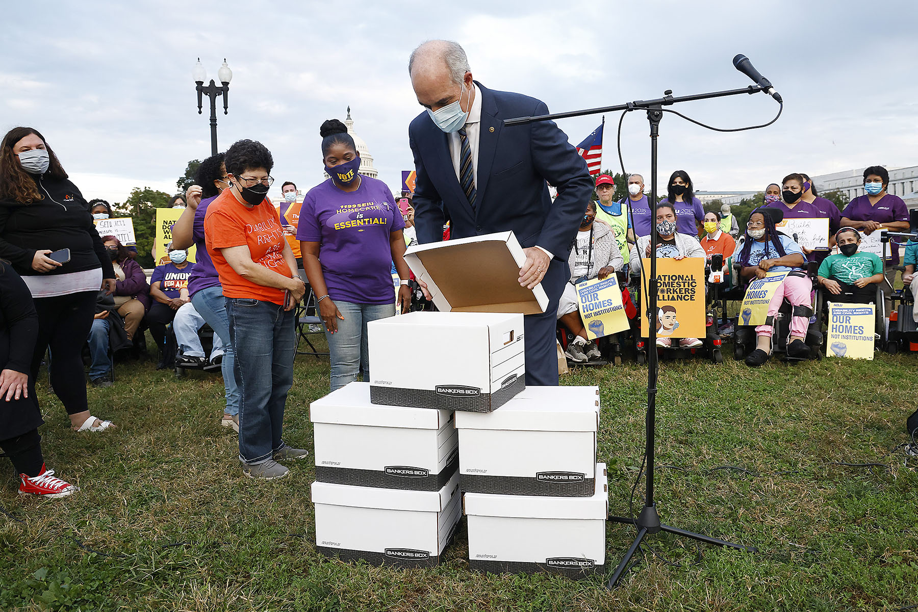 Sen. Bob Casey opens boxes of stories from home care recipients, family care givers and home care workers at a 24-hour vigil outside of the Capitol building.