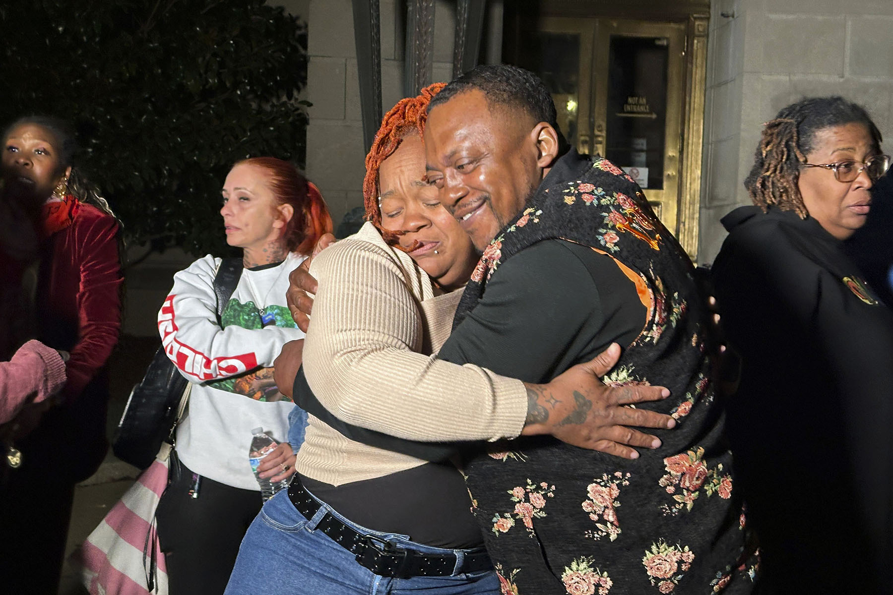 Breonna Taylor's mother, Tamika Palmer, hugs a friend in reaction to Brett Hankison's conviction in federal court.