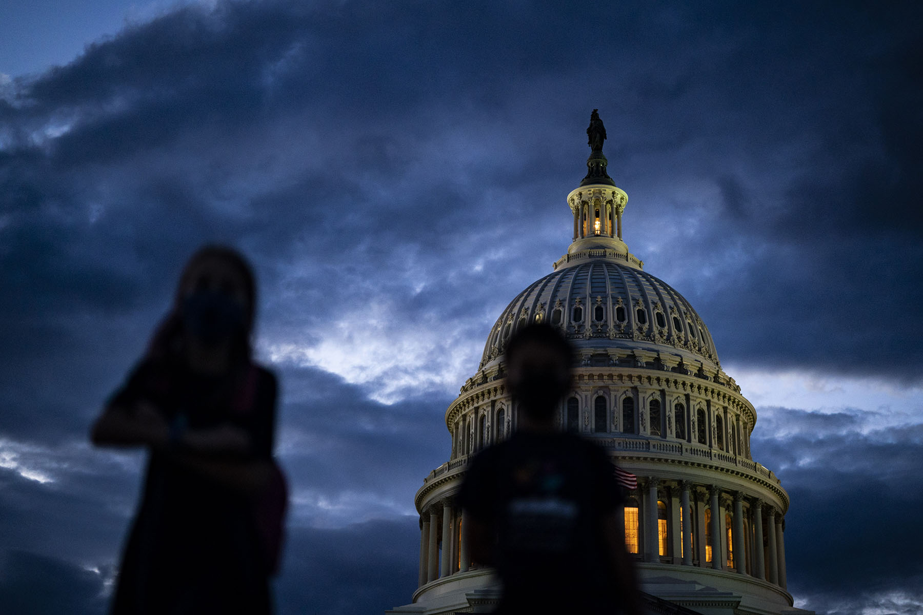 Silhouettes of children as seen in front of the Capitol Dome as the sun sets on Capitol Hill.