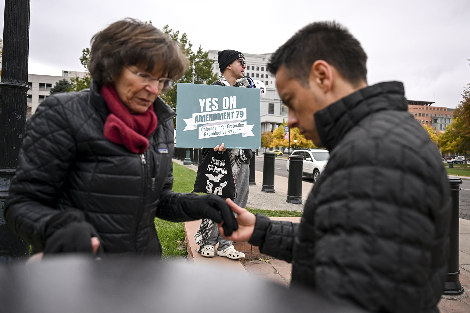 A counter-protester is seen as others rally against Amendment 79 at the Colorado State Capitol.