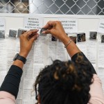 A woman handles receipts from early voting during election night at the Fulton County Elections Hub and Operation Center in Fairburn, Georgia.