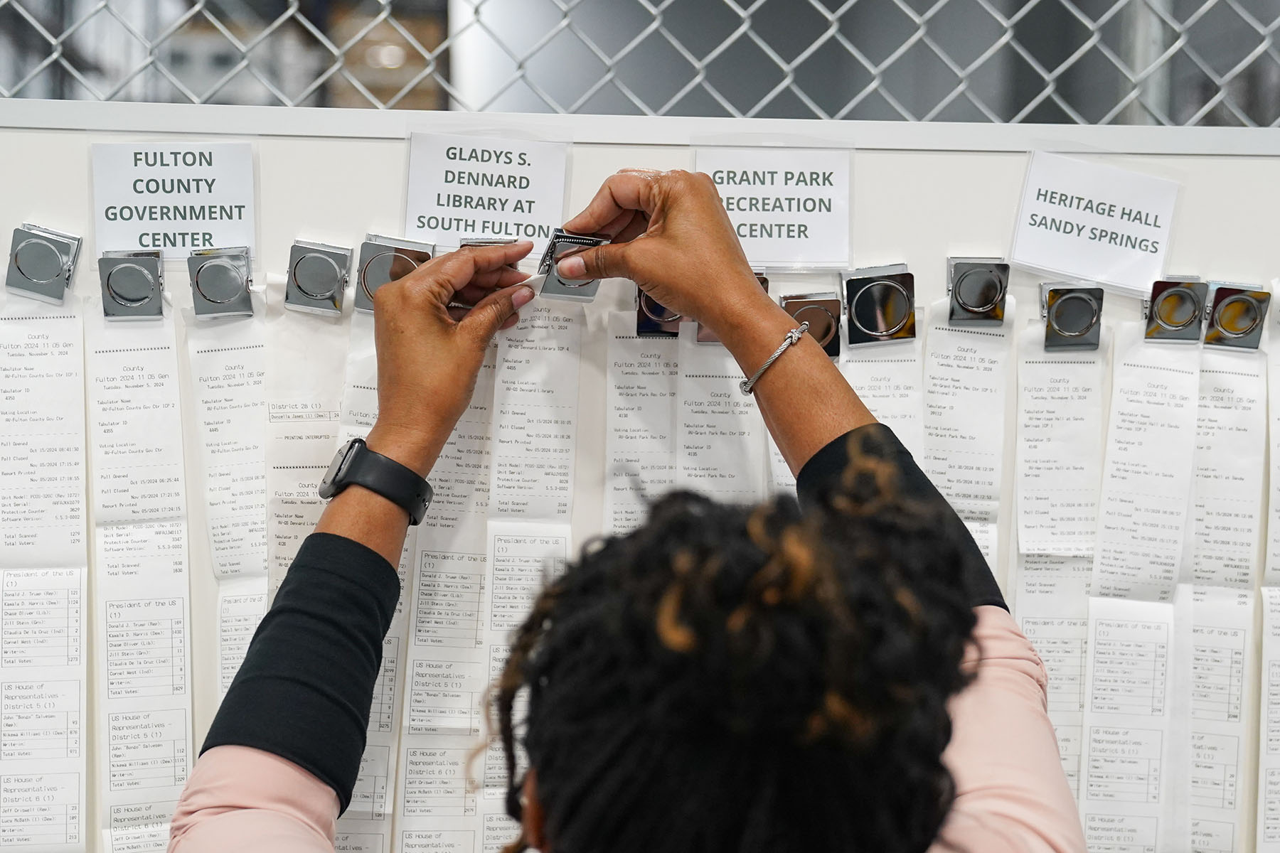 A woman handles receipts from early voting during election night at the Fulton County Elections Hub and Operation Center in Fairburn, Georgia.