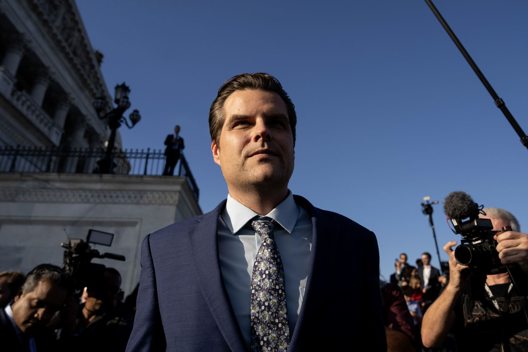 Photographers and journalists surround Matt Gaetz as he leaves the Capitol.