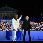 Oprah Winfrey holds up Vice President Kamala Harris' hand as she arrives onstage during a campaign rally on the Benjamin Franklin Parkway in Philadelphia, Pennsylvania.