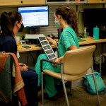 A family physician and her resident look over an ultrasound at a reproductive health clinic