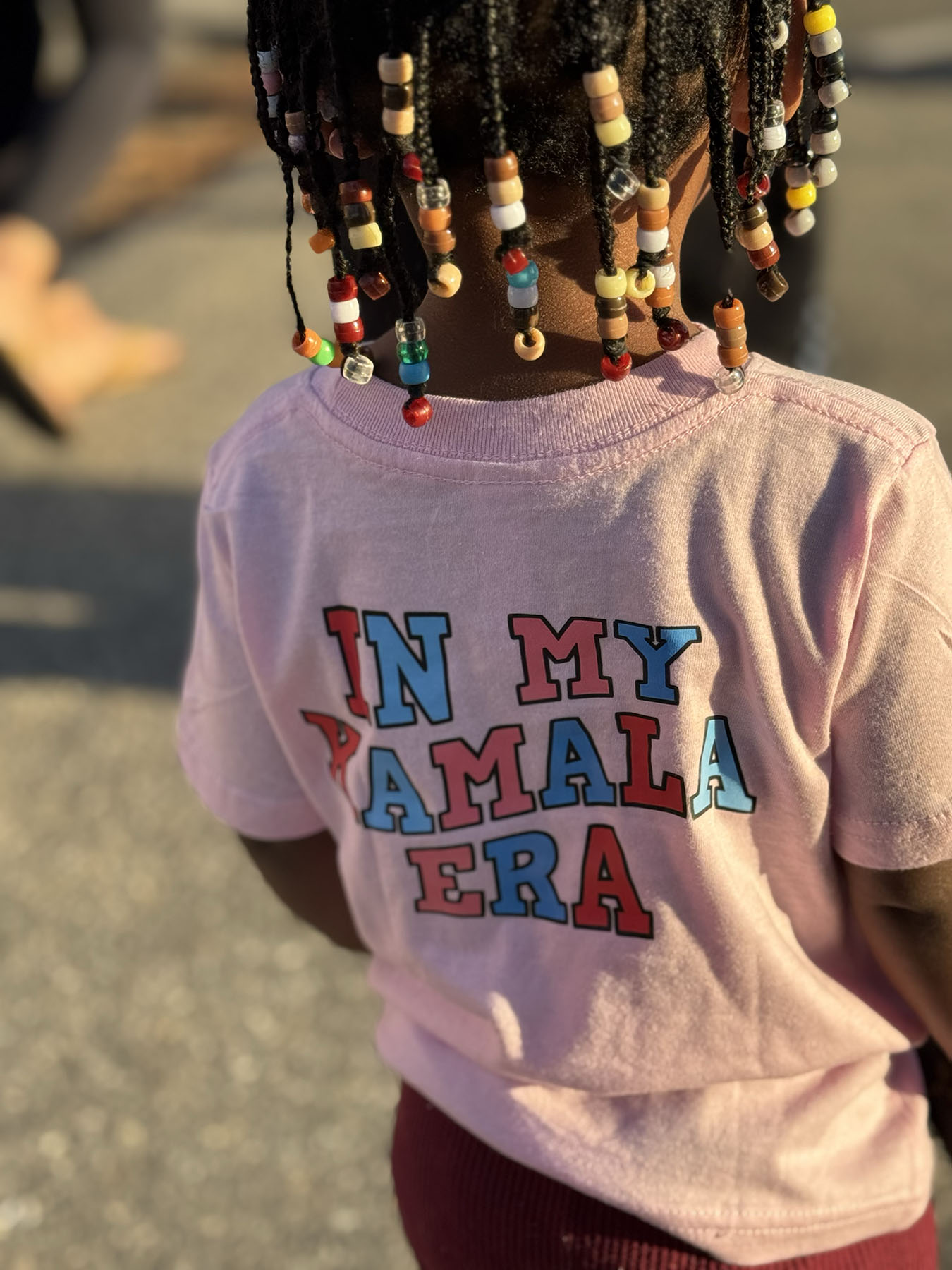 Camilla Thompson's 2-year-old, Ava, wears a pink Kamala Harris shirt.