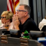 Joseph Komrosky listens during a special meeting about textbook.