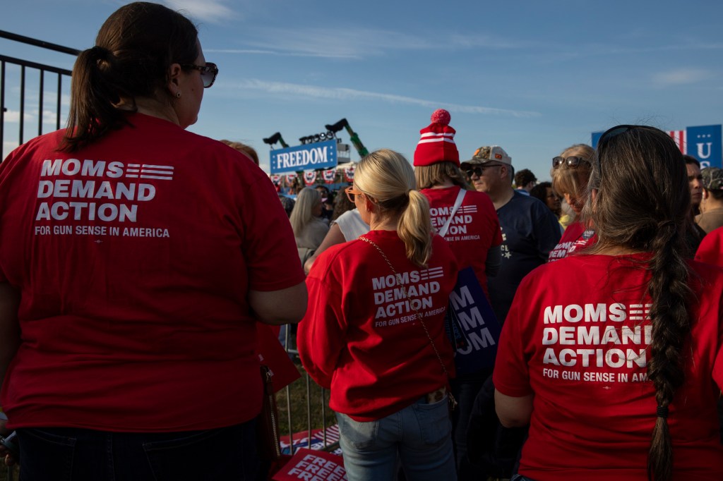 Several people wearing red shirts with the words 