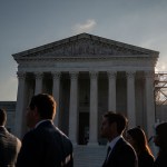 People stand outside the U.S. Supreme Court.