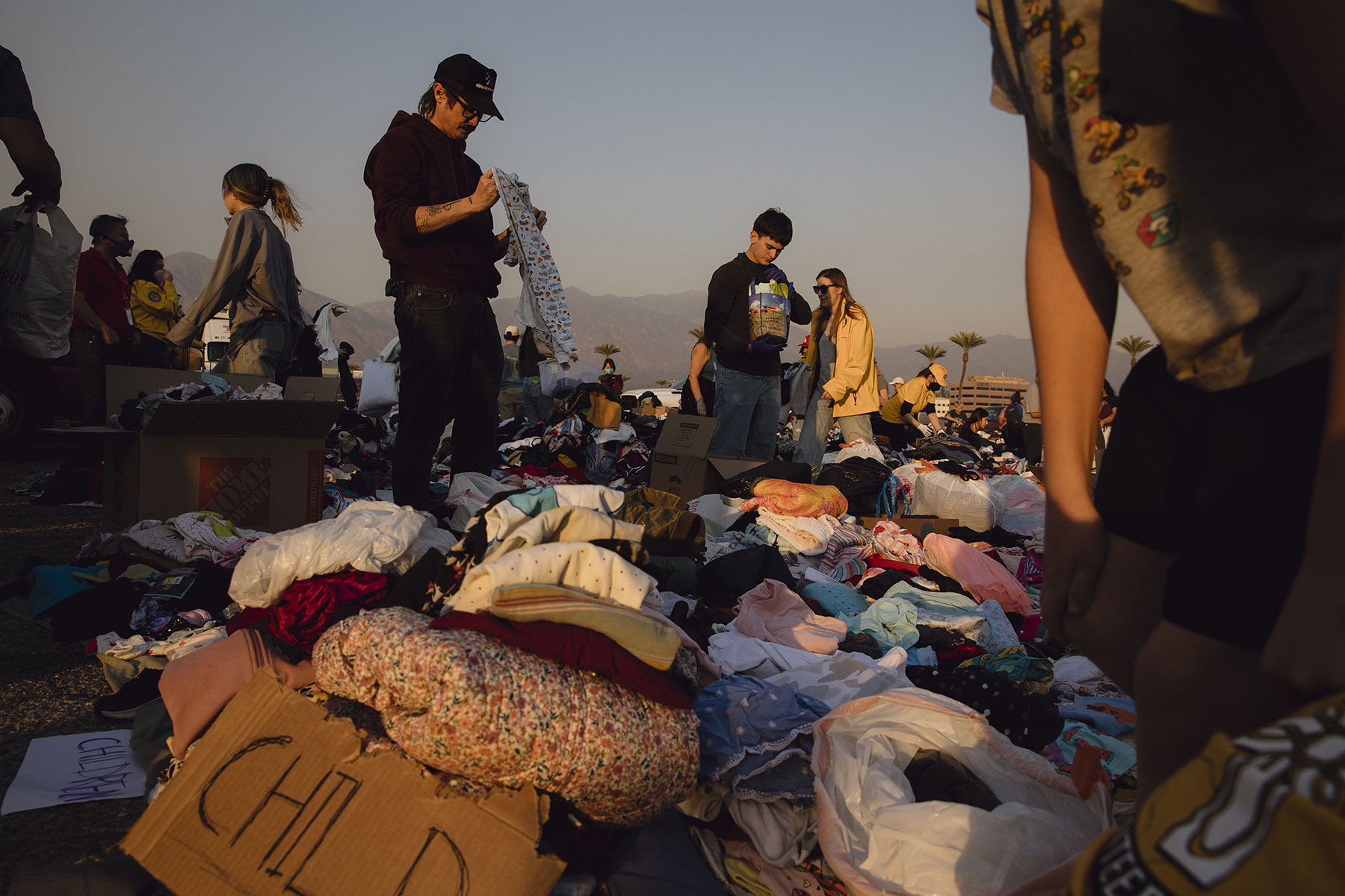 At a self-made donation center at Santa Anita Park in Arcadia, California, people sort through clothes donated to those affected by the Eaton Canyon fire.