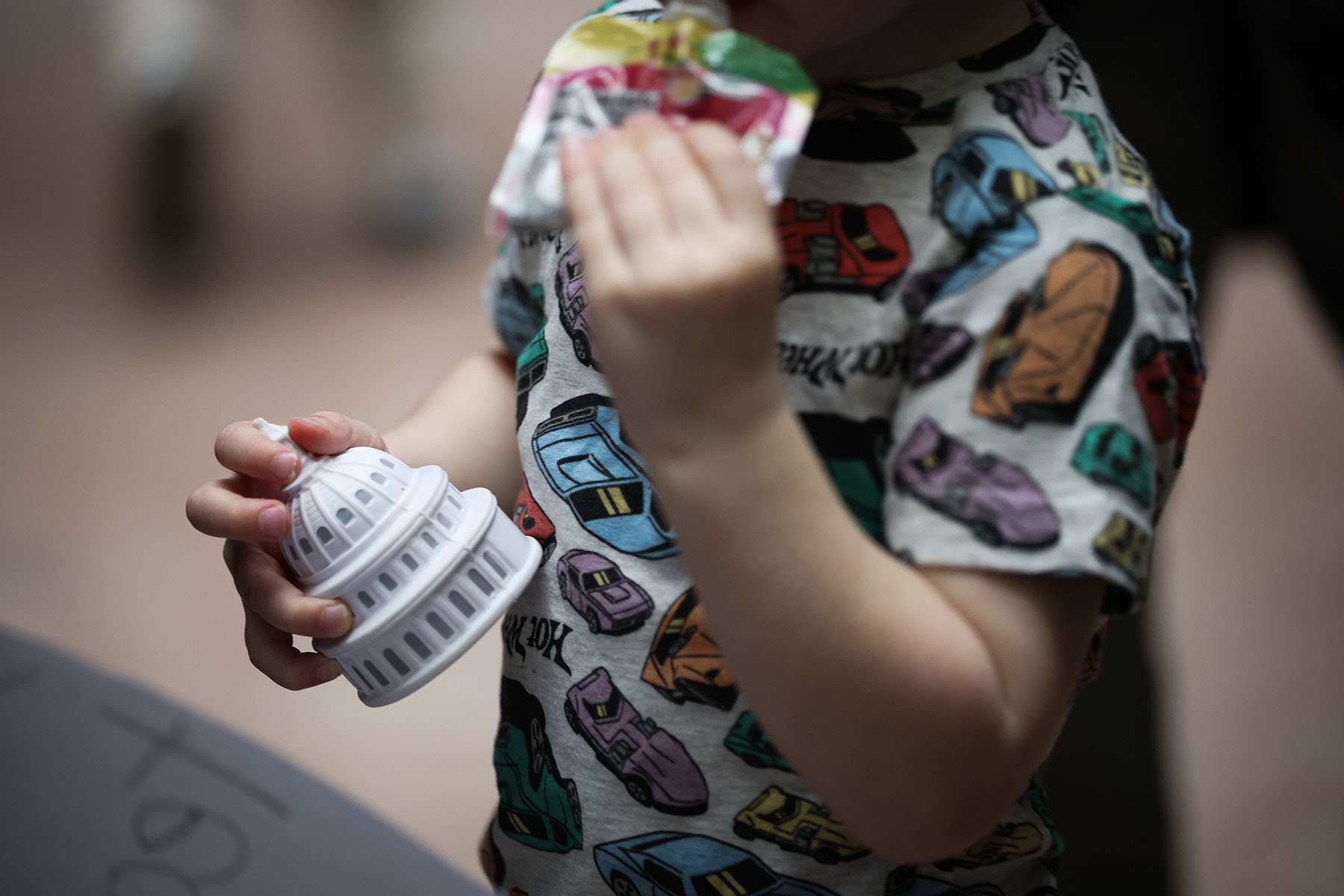 A child holds a dome stress ball during a rally at the Capitol.