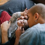 Two parents hold their child.
