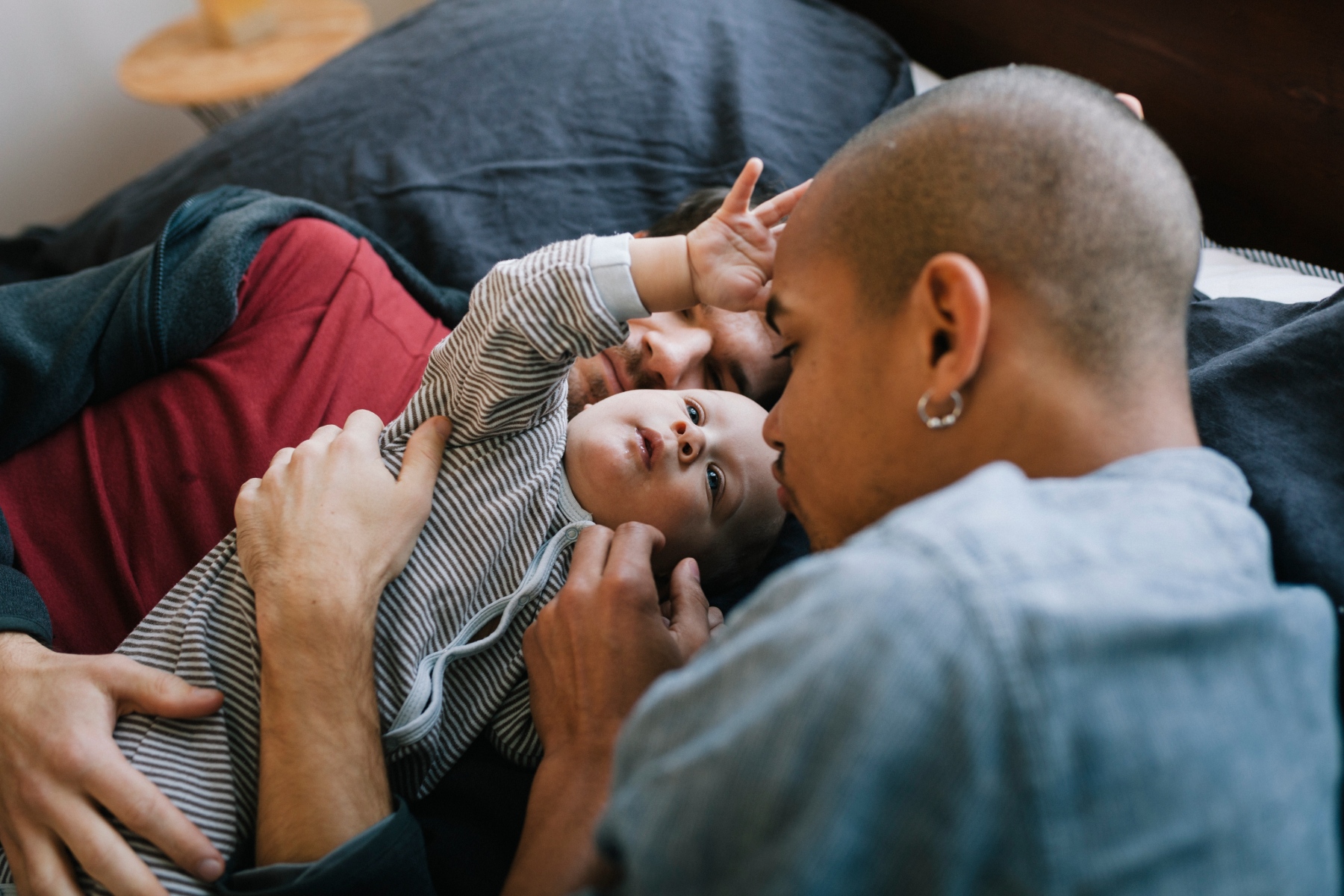 Two parents hold their child.