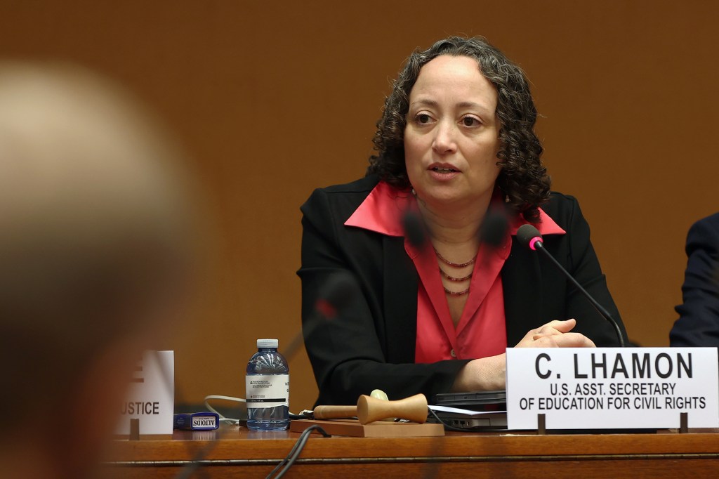Catherine E. Lhamon speaks while sitting at a desk.