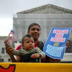 People participate in a protest outside the Supreme Court over President Donald Trump's move to end birthright citizenship as the court hears arguments over the order.