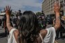 A woman raises her hands in front of Los Angeles Mounted Police officers during the No Kings Day protests taking place across the nation.