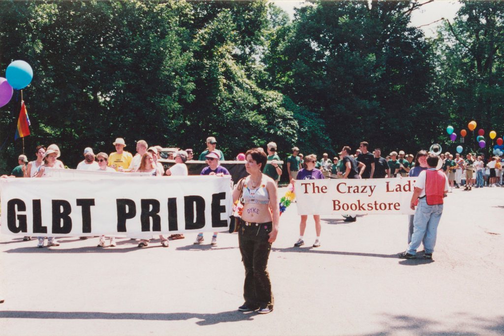 Archival image of people marching down the street for Pride.