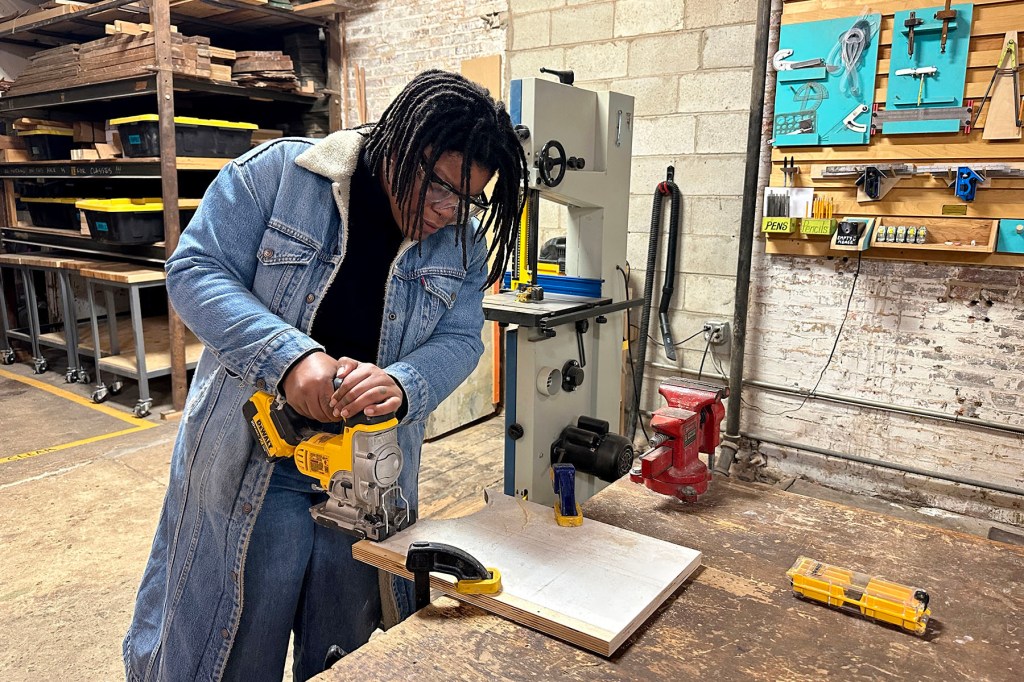 A homeowner practices using the jigsaw at the Station North Tool Library.