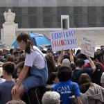 A crowd protests outside the Supreme Court.
