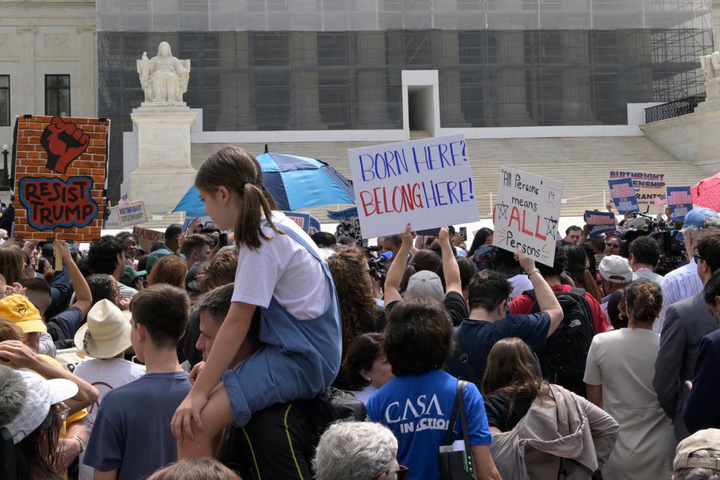 A crowd protests outside the Supreme Court.