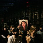 Protestors carry a sign showing Breonna Taylor's face.