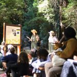 Two rangers talk to a group of park visitors.