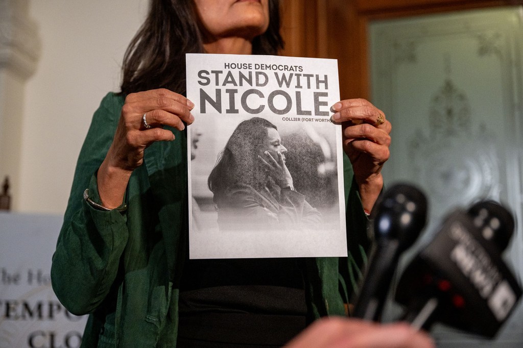 Democratic Texas Rep. Penny Morales Shaw displays a poster of Democratic Texas Rep. Nicole Collier during a news conference outside of the House chamber in the Texas State Capitol.