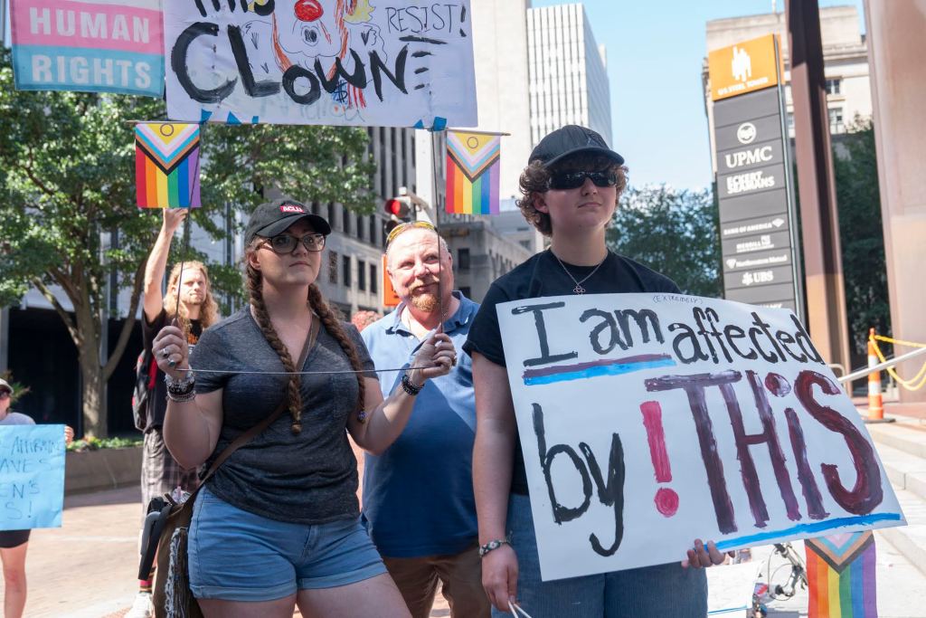 Lee and Nicole attend a protest against UPMC's cuts to gender-affirming care for patients under 19.