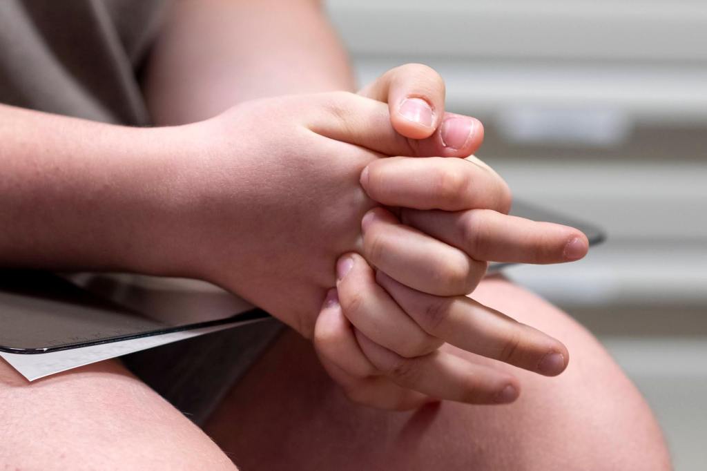 Lee squeezes his hands as he waits for his doctor at UPMC's University Center Medical Building.