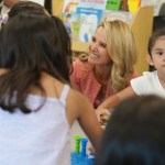 Jennifer Siebel Newsom is seen smiling as she plays with children in a classroom.