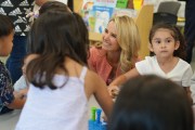 Jennifer Siebel Newsom is seen smiling as she plays with children in a classroom.
