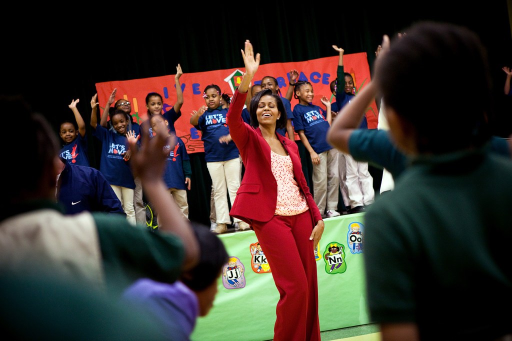 First Lady Michelle Obama exercises with students and Olympic athletes during a Let's Move event.