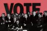 President Lyndon B. Johnson signs the Voting Rights Act of 1965 surrounded by civil rights leaders, including Martin Luther King Jr., with the word 