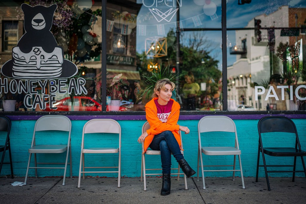 Kat Abughazaleh sits outside a restaurant near her campaign office in the Rogers Park.