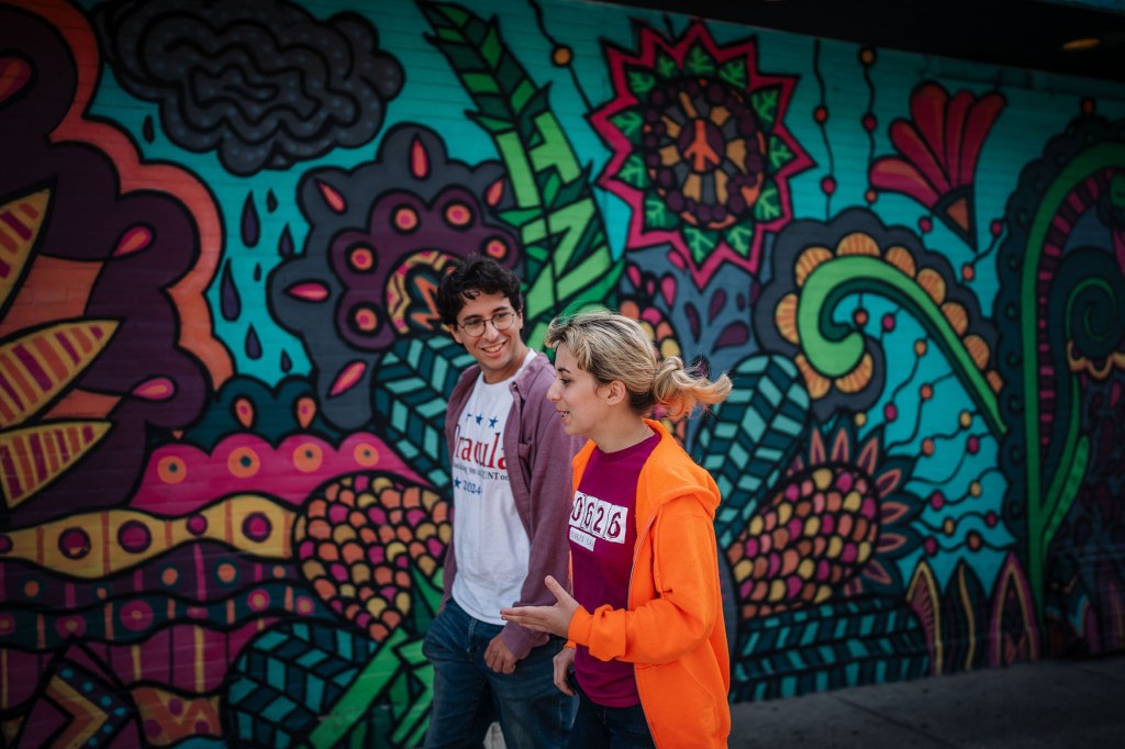 Kat Abughazaleh walks with a campaign staffer in the Rogers Park neighborhood August 26, 2025, in Chicago.