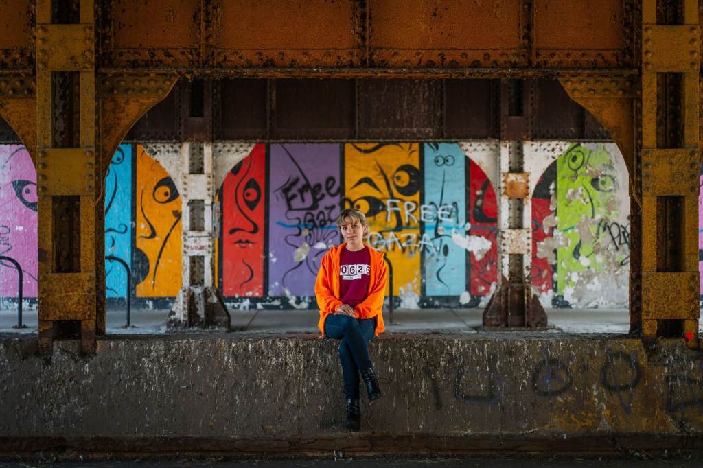 Kat Abughazaleh sits under a bridge in the North Side neighborhood of Rogers Park.