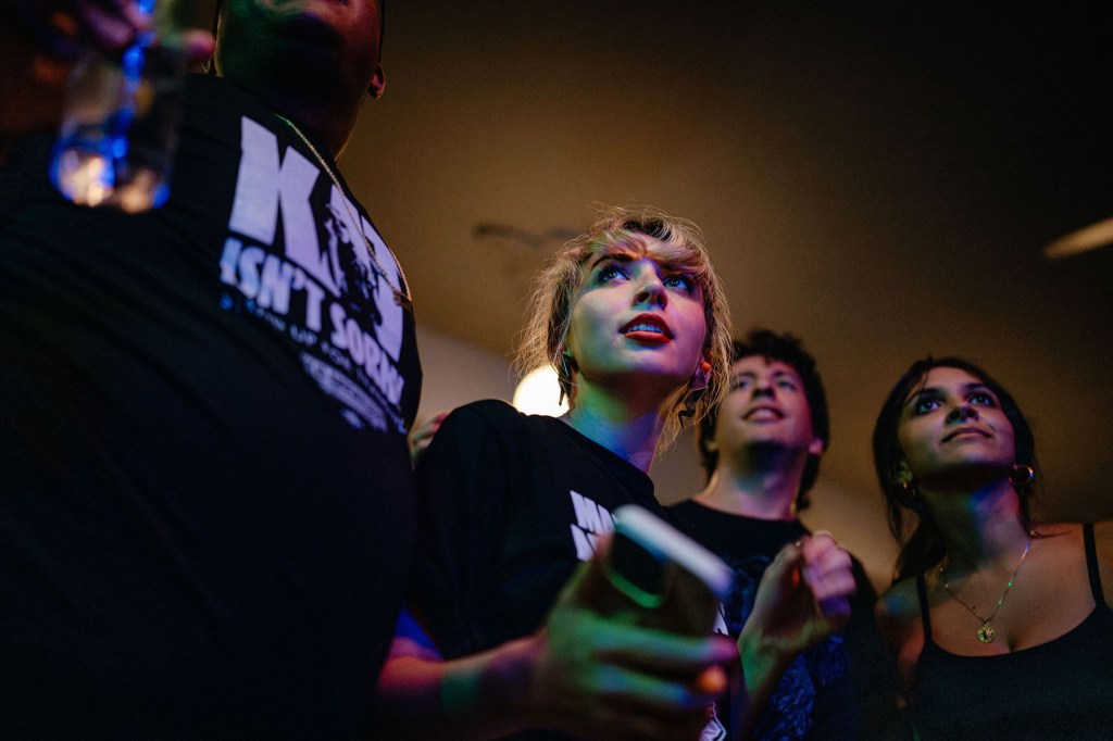 Kat Abughazaleh listens to the bands with friends and supporters during “Punks for Progress.”