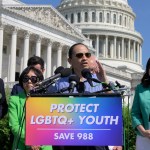 Politicians stand in front of a podium that says 