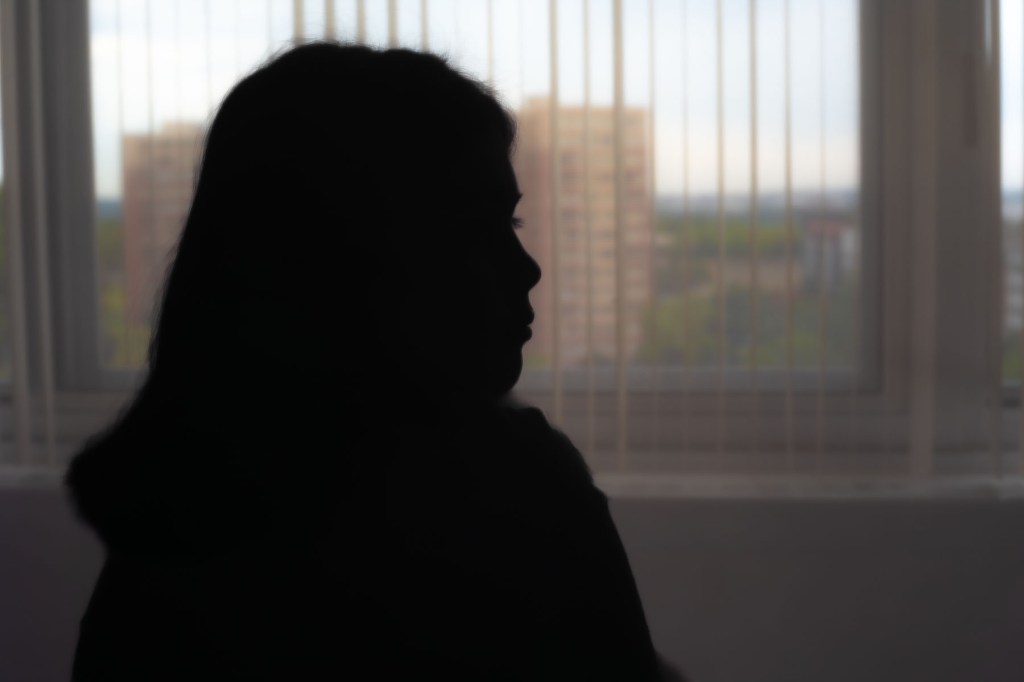 Em's silhouette is seen as she poses for an anonymous portrait.